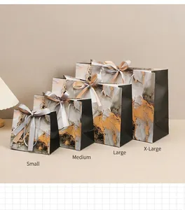 Black marble pattern gift bags in four sizes with elegant gold silk bow handles