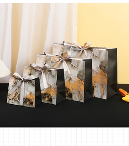 Black marble pattern gift bags in four sizes with elegant gold silk bow handles