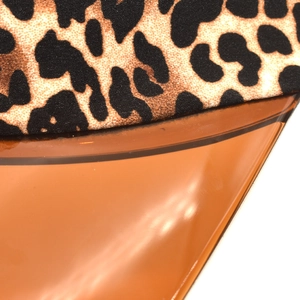 Close-up of leopard print fabric joined with translucent amber PVC sun visor brim