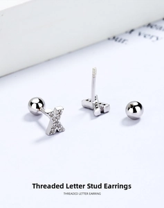 Close-up of S925 silver letter X stud earring with zircons and secure screw back ball