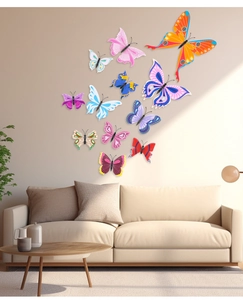 Vibrant PVC butterfly wall stickers in various colors flying above a beige sofa