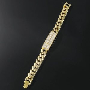 Close-up of golden Cuban link bracelet with iced-out center plate and luxury buckle
