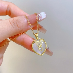 Elegant gold titanium steel heart necklace featuring white cat eye stone and diamonds