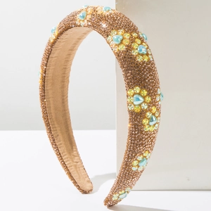 Detail of padded headband with champagne rhinestones and blue heart-shaped gems
