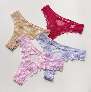 Detail of four lace thongs with polka dot mesh, low waist and heart shaped metal buckle