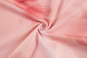 Detail of pink and white marble pattern fabric with elegant spiral folds and twill texture