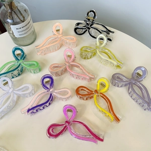 Bow ribbon shark hair clips in assorted colors made of acrylic for stylish updos