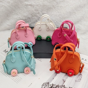 Group of 5 colorful car-shaped mini purses made of lychee texture leather on white fur