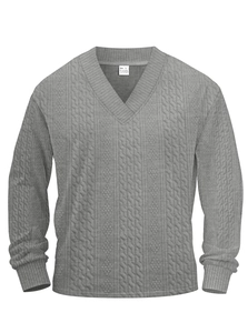 Detail view of the collar size label and textured jacquard knit fabric on a V-neck sweater