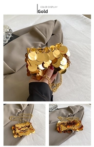 Detail of gold sequin mini evening bag with metallic chain strap and reflective texture