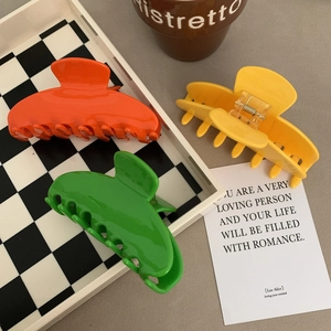 Large colorful acetate hair claw clips in orange green and yellow for elegant hair styling