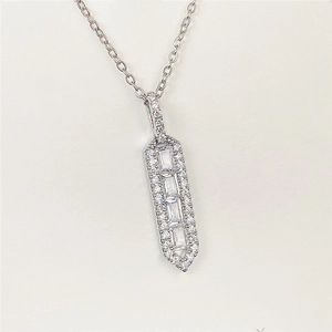 Macro shot of silver baguette-cut crystal pendant necklace with pave-set accents
