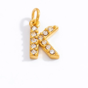 Detail of 18K gold letter K pendant featuring sparkling crystal zircon stones