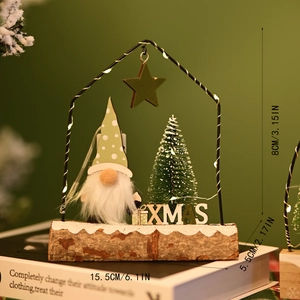 Detail of wooden Christmas gnome ornament with warm LED lights and mini tree in house frame