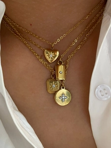 Detail of four-layer gold plated necklaces with heart, bar, and crystal pendants