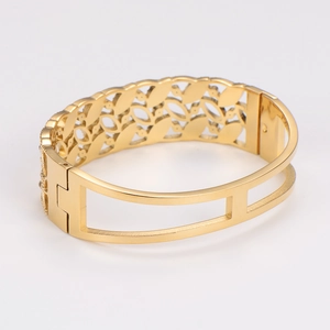 Vintage hollow gold-plated stainless steel cuff bracelet with intricate floral leaf pattern