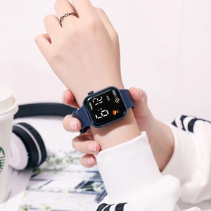 Deep blue LED digital watch with silicone strap shown in a modern lifestyle setting
