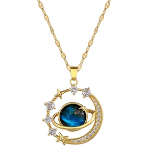 Gold celestial necklace with blue planet pendant featuring moon, stars and inlaid stones