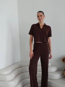 Deep brown knit set featuring a short sleeve polo shirt and straight leg trousers on a model