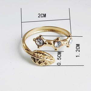 Macro shot showing dimensions of a 18K gold plated leaf ring with sparkling crystals