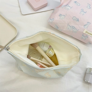 Top-down view of spacious cosmetic bags with cute cat prints and secure zipper closures