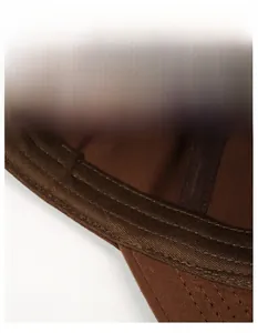 Detail view of the wide moisture-wicking sweatband and breathable vents inside the cap
