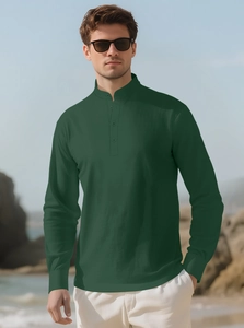 Detail of dark green linen shirt fabric texture on a male model at the beach