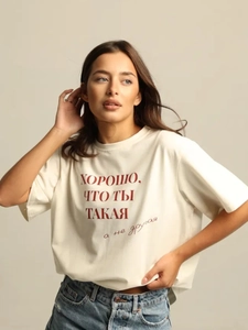 Classic cream cotton T-shirt with red Russian text paired with blue jeans in a studio shot