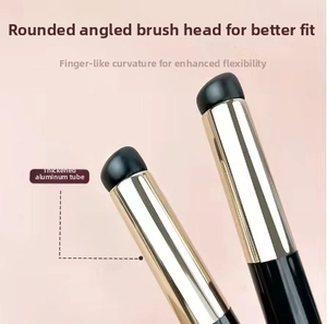 Detail of slanted round makeup brush featuring a thickened gold aluminum ferrule