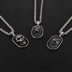 Punk style silver skull dragon and lion head pendants with twisted chains on black background