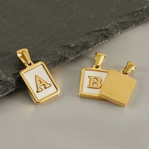 Gold rectangular letter pendants with white mother of pearl inlay on stone and silk