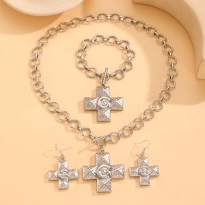 Detailed set of silver cross jewelry with spiral texture featuring OT buckle and earrings