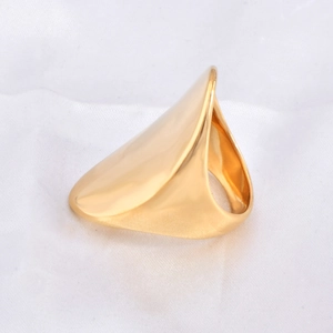 Close-up of a wide curved 18k gold plated titanium steel ring on white silk background