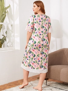 Detailed view of tropical floral print nightgown with white lace trim and satin texture