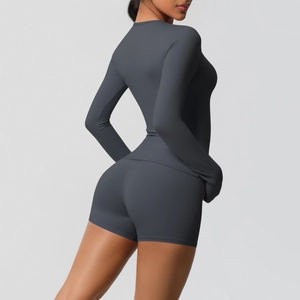 Detail view of the back and side of a dark gray slim-fit yoga set with high-waisted shorts