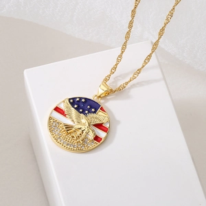 Gold necklace with American flag and eagle pendant displayed on a white stand