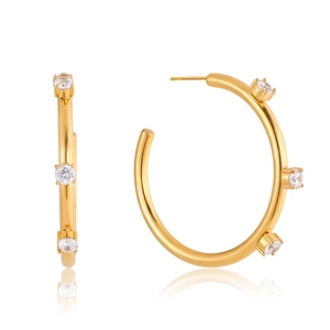 Macro view of gold-plated stainless steel hoop earrings with three round zircon stones