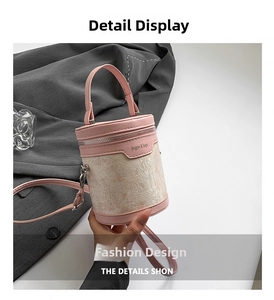 Close-up of pink and beige leather bucket bag with jingpin branding and metal chain