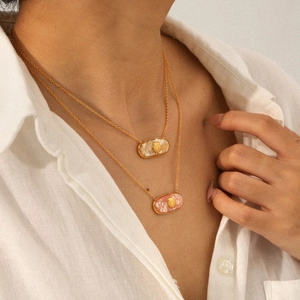 Layered gold stainless steel necklaces with shell patterns in pink and white resin