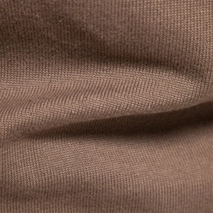 Close-up of soft dark brown knitted fabric showing detailed stitch texture and quality