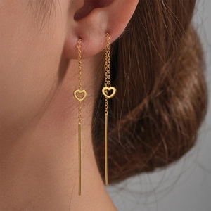 Close-up of elegant gold S925 silver heart tassel threader earrings worn by a model