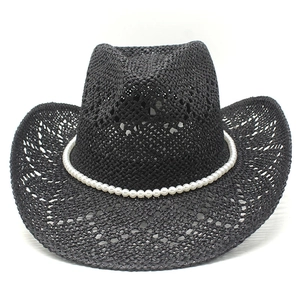 Detail of black straw cowboy hat featuring hollow weave texture and pearl bead chain