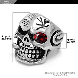 Macro detail of gothic skull ring featuring a red gemstone eye and vintage silver finish