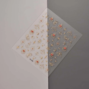 Detail of bohemian nail art stickers featuring gold sun, moon, and heart shapes