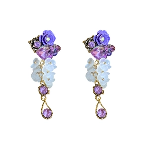 Vintage gold earrings with purple rose, heart crystal and white flower beads on white background