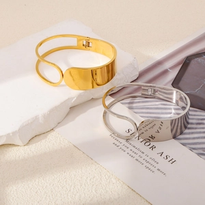 Minimalist wide hollow cuff bracelets in gold and silver with mirror polished finish