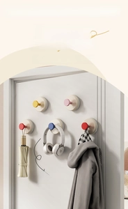 Wall-mounted suction cup hooks for hanging umbrellas and headphones on doors