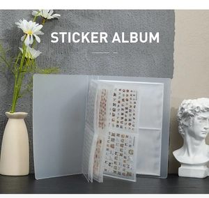Transparent sticker album organizer with ring binder shown on a wooden desk with a vase