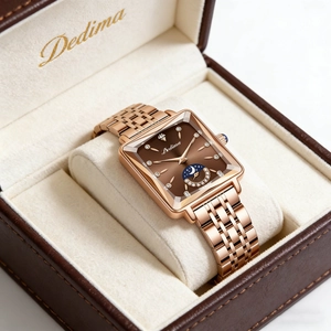Close-up of a square rose gold watch with moon phase dial in a brown leather gift box