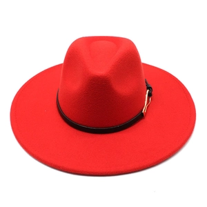 Detail of red wool felt fedora featuring a black leather band and gold metal buckle